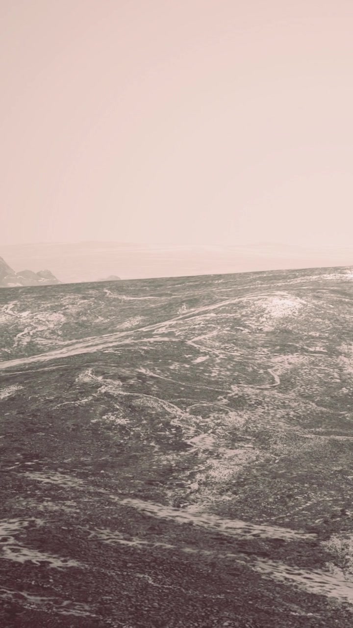 Waves move toward rocky shore during cloudy day at coastal location