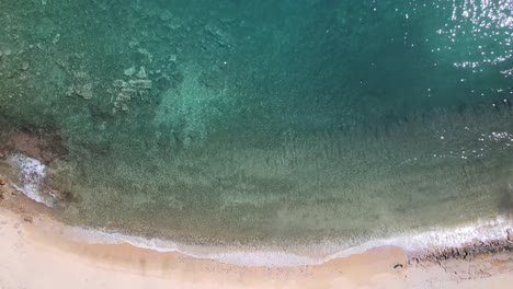 Overhead-Aerial-drone-clip-over-a-beautiful-beach-in-Kavala,-Macedonia,-Greece