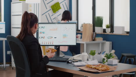 Businesswoman-having-lunch-break-sitting-at-table-eating-fastfood-delivery-in-company-office