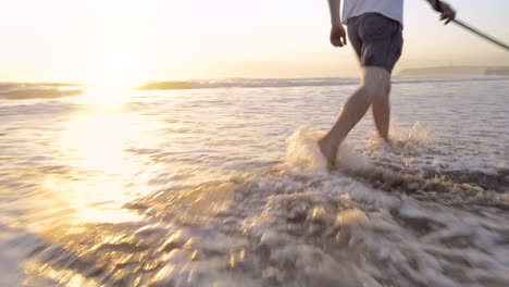 happy man running dog on beach lifestyle steadicam shot