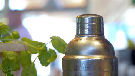 zoomed view of a shaker cap unscrewed by two human hands