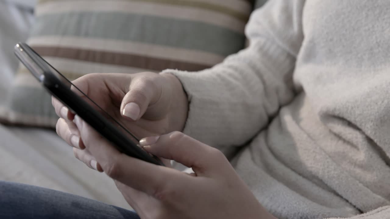Close-up of Person's Hands Typing and Swiping on Smartphone