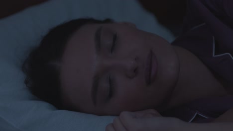 woman sleeping in bed at night