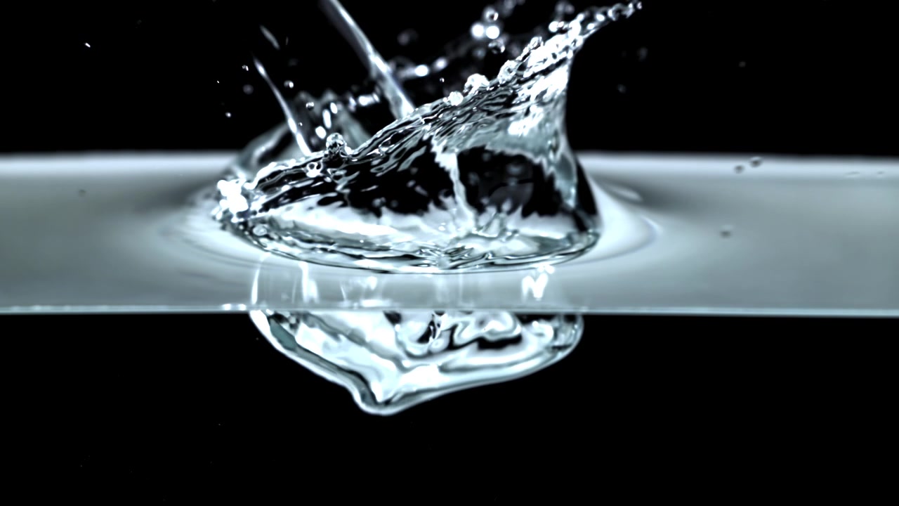 Slow Motion Water Drop Splashing into Clear Liquid on Black Background