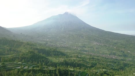 aerial view of the marapi volcano and the rural land around it with plantations in java indonesia