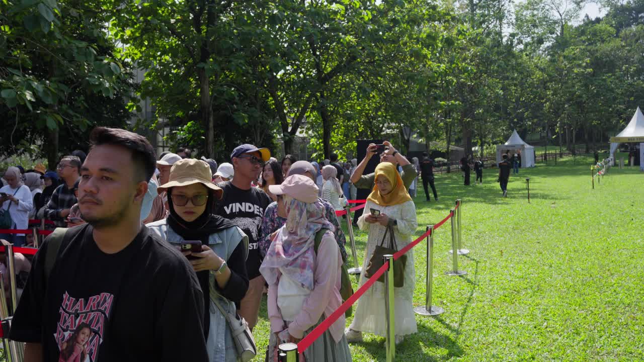 Indonesian Crowd Queueing To Enter During An Outdoor Event In Kebun Raya Bogor, Indonesia. Tracking Shot