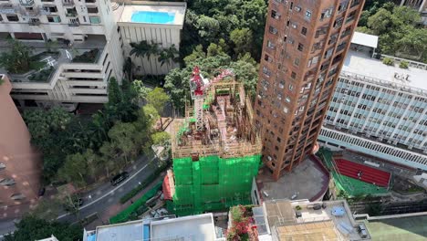 high rise building construction site with bamboo scaffolding in hong kong