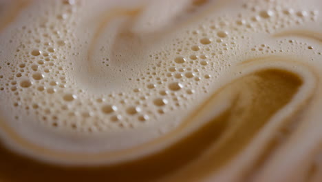 close-up of creamy coffee foam swirl