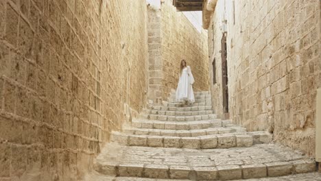 girl with a puffy white dress going down the stairs gently