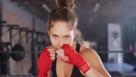 video of fit caucasian woman boxing at gym