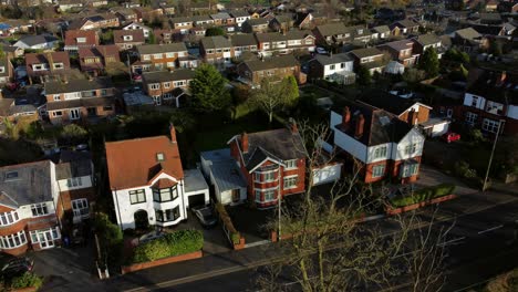 aerial descending view expensive british middle class houses in rural suburban neighbourhood