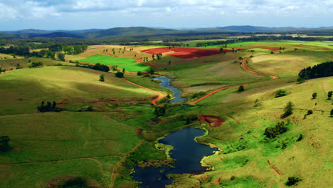 aerial view of marsh between the green hills in rural area of atherton in australia