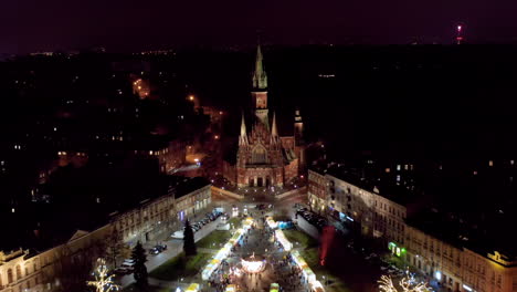 drone view of christmas stalls and carousel on the podgorski square with st