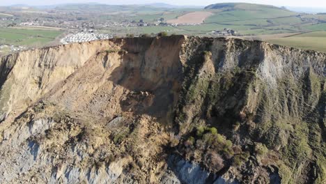 aerial over massive cliff fall debris into english channel at seatown in dorset