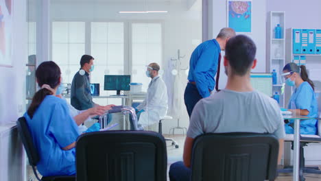 doctor with visor and patient in examination room