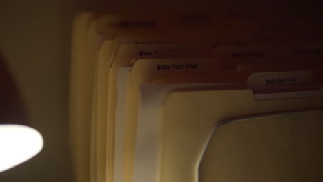 close up of beta test manilla folders in creepy dark laboratory