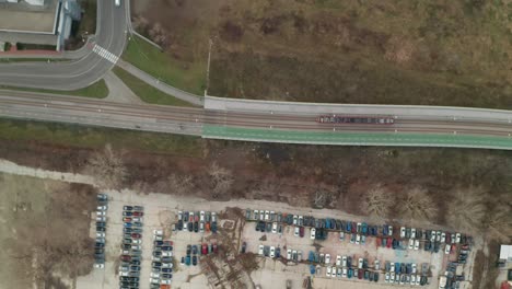 aerial view of tram on bridge and parking lot
