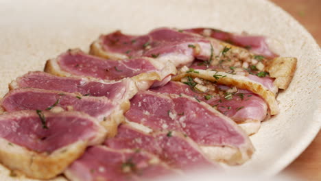 macro of salt sprinkled into the plate of beef tataki