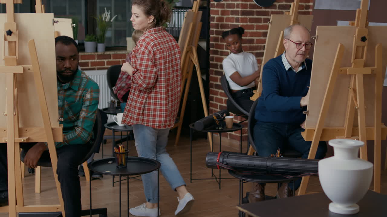 Art class teacher analyzing drawing practice on canvas