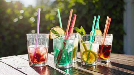 vibrant summer drinks on a sunlit wooden table, captured at a low angle