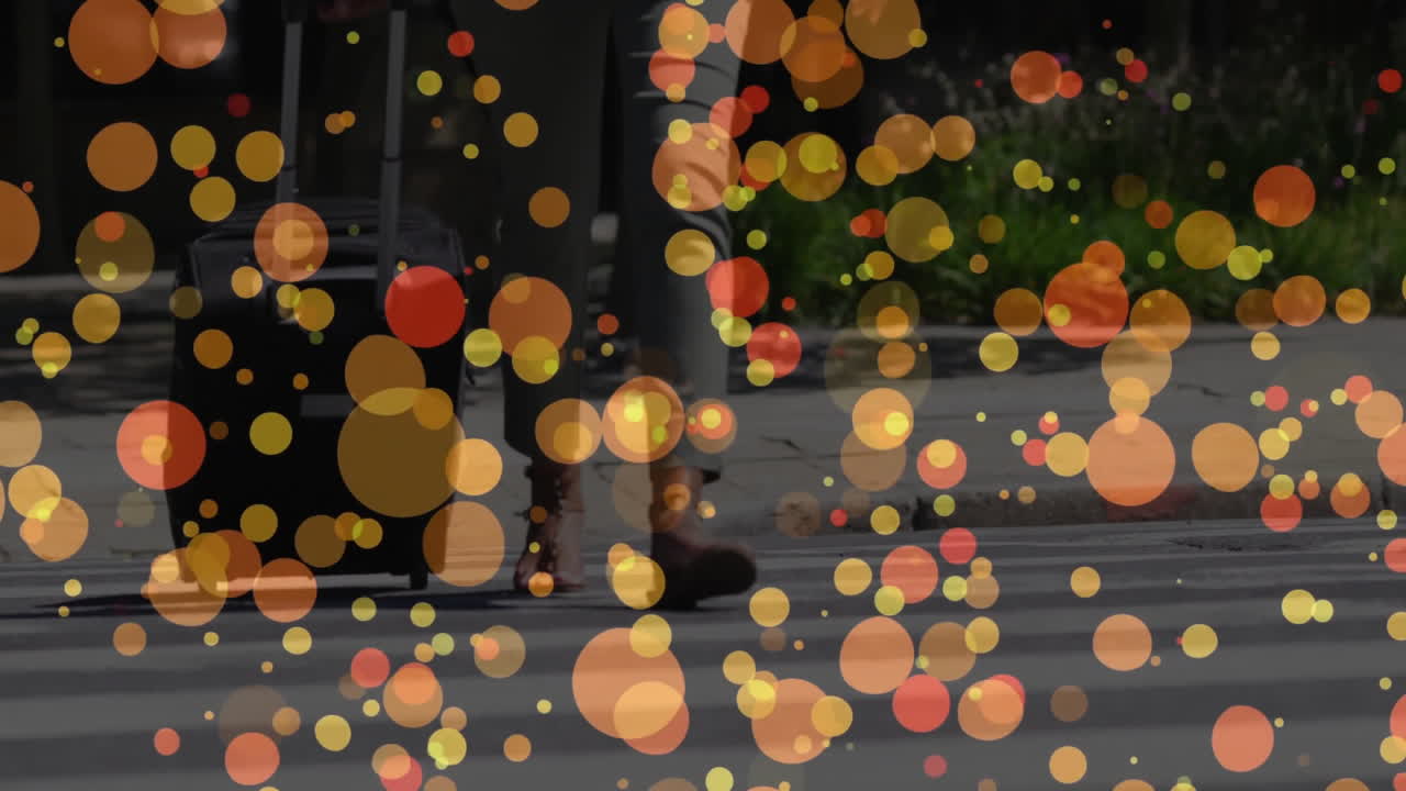 woman walking crosswalk pulling rolling suitcase with colorful bokeh highlighting travel marketing