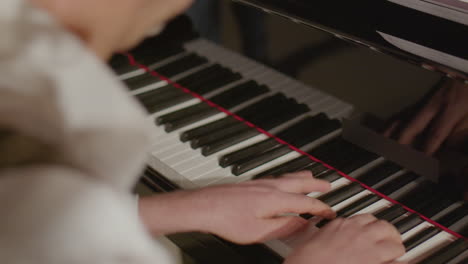 close up of musician playing grand piano