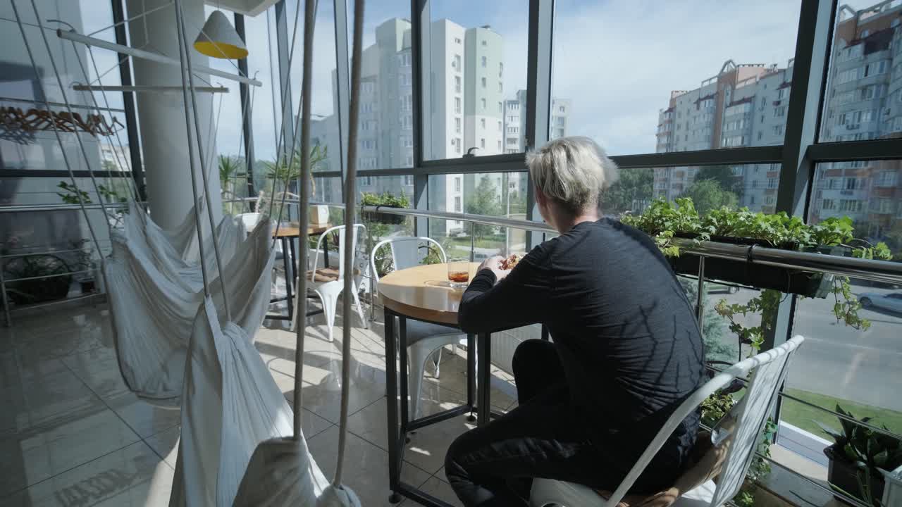 un tipo comiendo una hamburguesa en un restaurante.