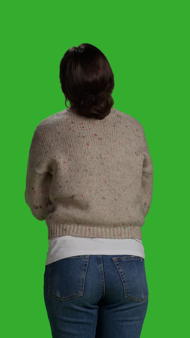 Vertical video: Back view of close up young adult greeting person with wave