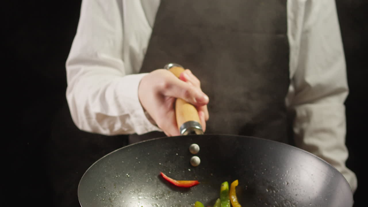 Chef Stir-Frying Vegetables in a Wok