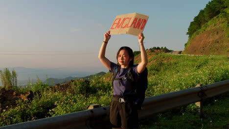 Asian-female-hitchhiker-wanting-to-immigrate-to-England,-Great-Britain