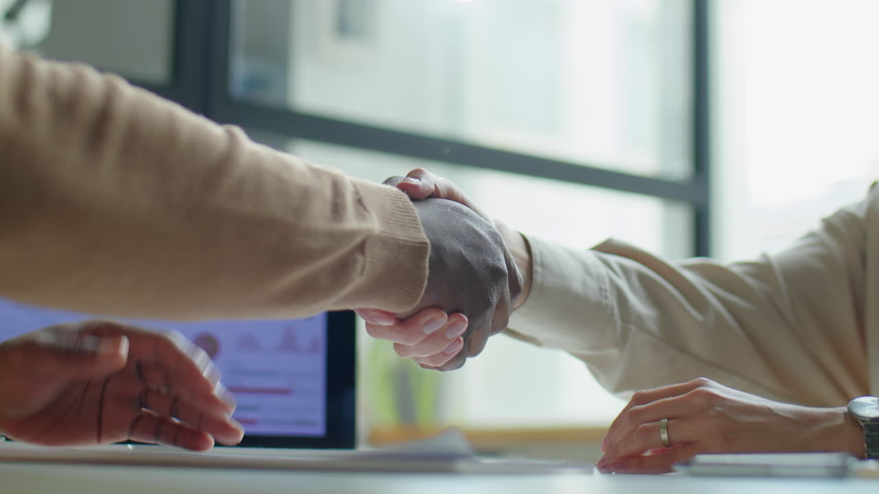 Diverse Coworkers Shaking Hands and Talking in Office