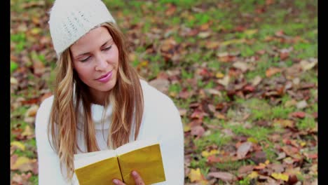 Woman-reading-a-book-in-park-on-autumn-day