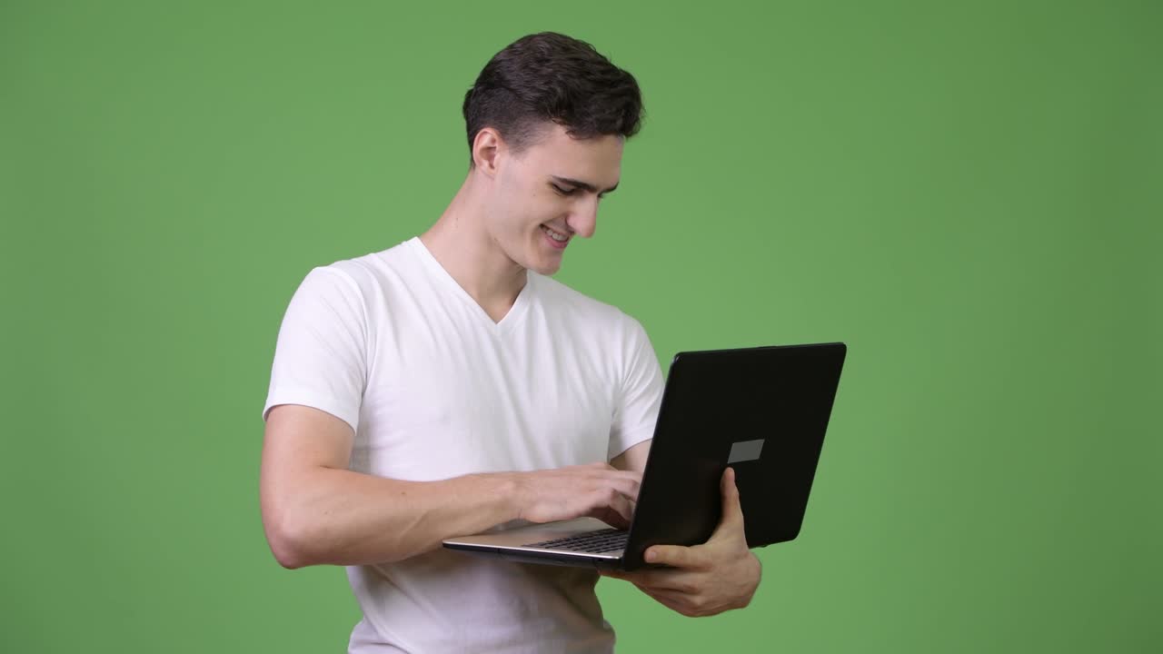 joven apuesto usando una computadora portátil