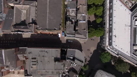 Dramatic-90-degree-drone-angle-of-brittish-city-centre-showing-rooftops-and-pedestrians