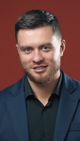 handsome bearded man smiling. young handsome bearded businessman against background. vertical video
