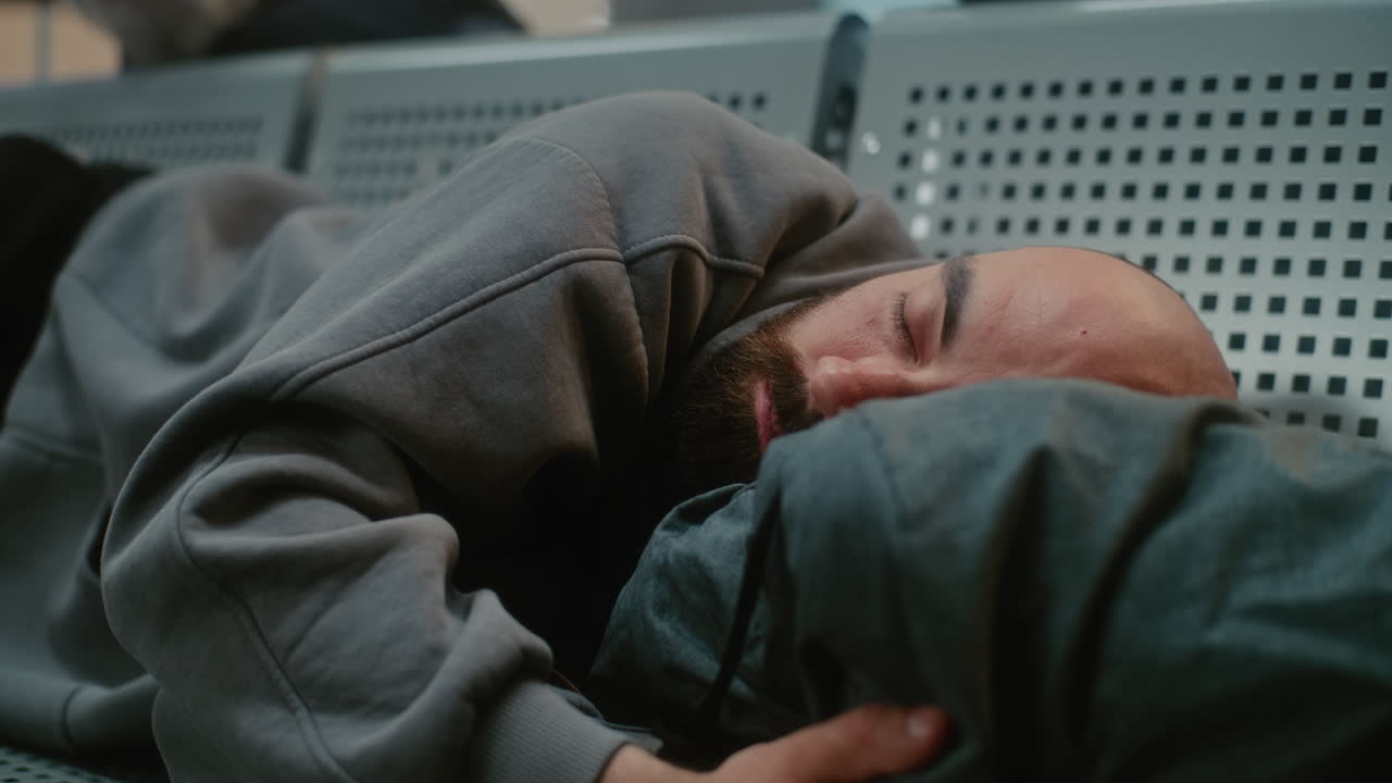 Man Sleeping in Airport Lounge