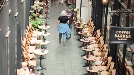 two people walking past coffee barker