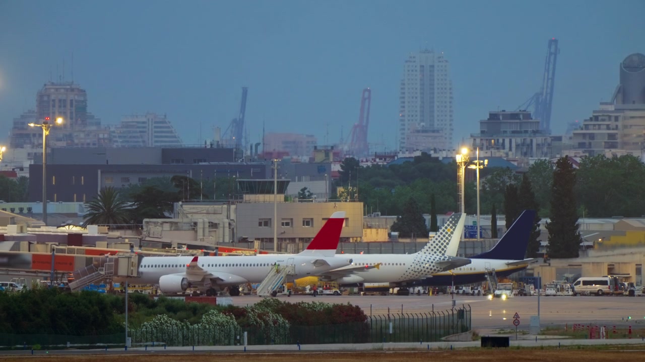 夕暮れの空港ターミナルに駐機する旅客機