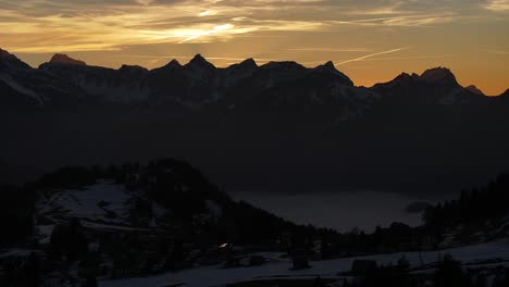 twilight hues over amden, weesen, with silhouetted glarus alps in schweiz, calm and serene