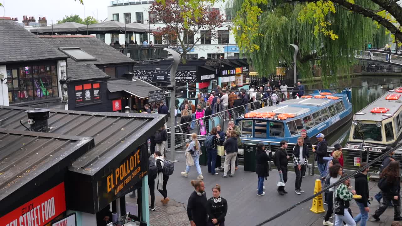Busy Canal Scene in London with Street Food Market and Boats