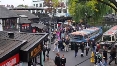 busy canal scene in london with street food market and boats