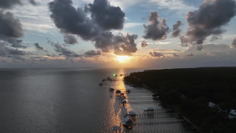 aerial reverse view of sunset over pelican point in alabama