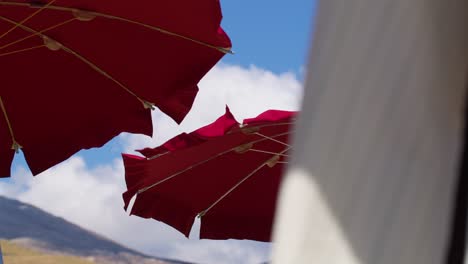 Colorful umbrellas at Guidaloca Beach in sunny Sicily, Italy