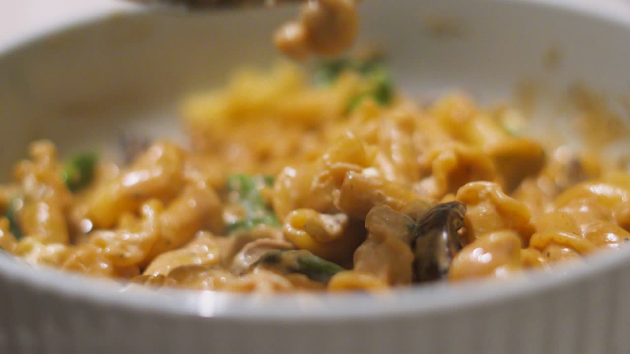 Fork Picking Up Food from Delicious Italian Mushroom and Mascarpone Creamy Pasta in a Bowl. Italian European Cuisine Food Footage.