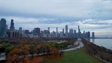 Chicago-Lake-Shore-Drive-Cars-Driving-Past-Grant-Park-In-Autumn-Under-Dark-Skys-Drone
