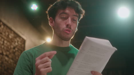 actor reading script and playing his role on theater rehearsal