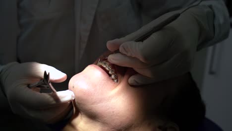 crop dentist working with dental instruments