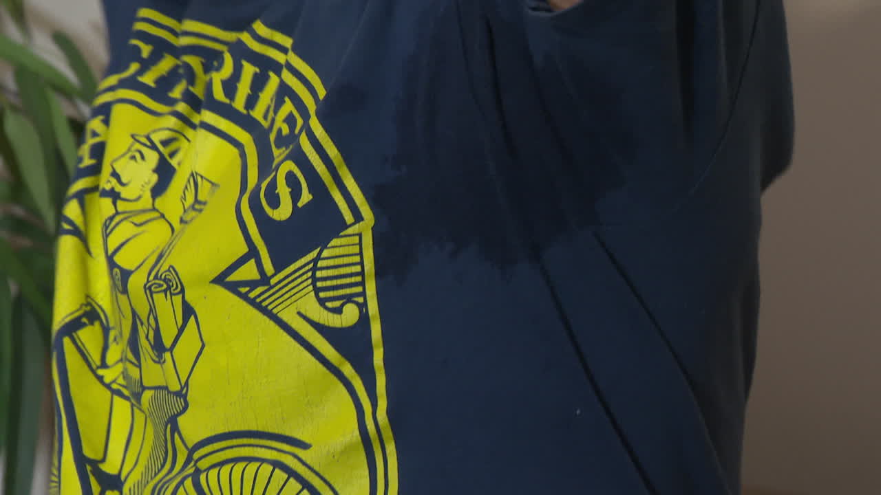 Man Sweating in a Postman Shirt