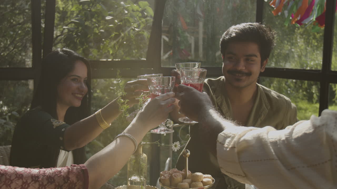 Diverse Group of Friends or Family Toasting and Celebrating in a Sunlit Room