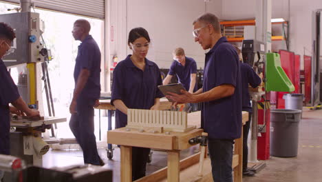 carpenters with machines in woodworking workshop shot on r3d